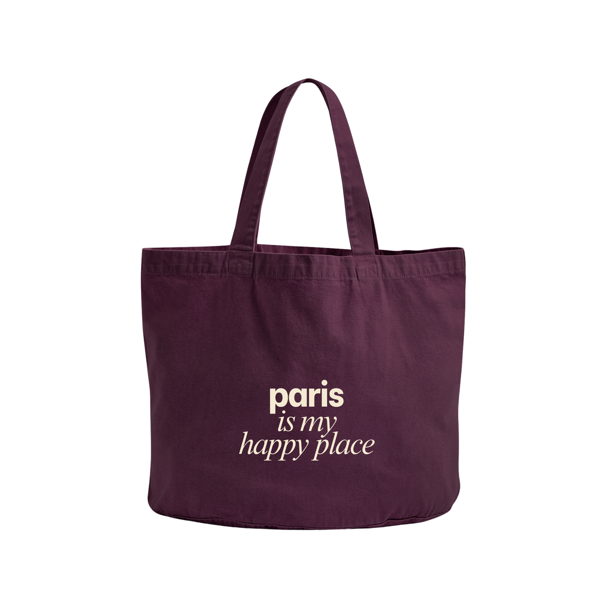 A dark purple canvas tote bag with the phrase 'paris is my happy place' printed in white on the front, set against a plain white background.