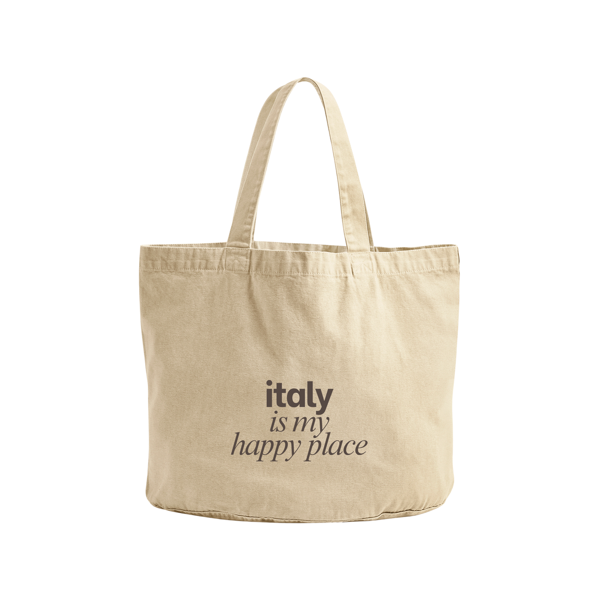 A natural beige canvas tote bag with two shoulder straps, featuring the printed text 'italy is my happy place' in black on the front, set against a plain white background.